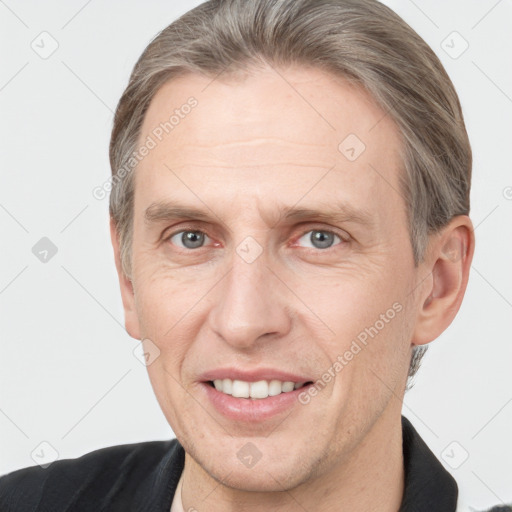 Joyful white adult male with short  brown hair and grey eyes