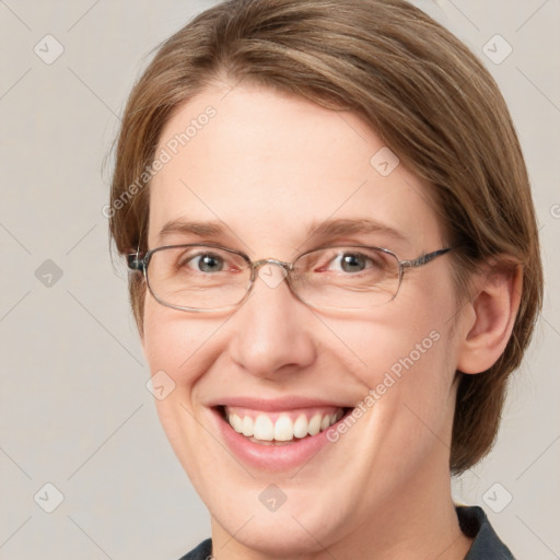 Joyful white adult female with medium  brown hair and blue eyes