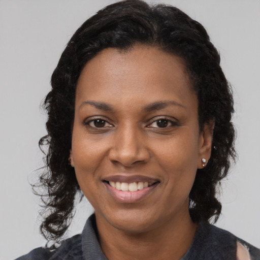 Joyful black young-adult female with medium  black hair and brown eyes