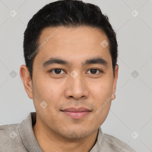 Joyful latino young-adult male with short  brown hair and brown eyes