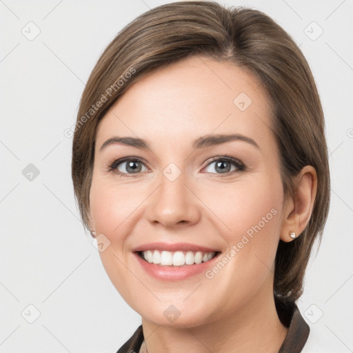 Joyful white young-adult female with medium  brown hair and grey eyes