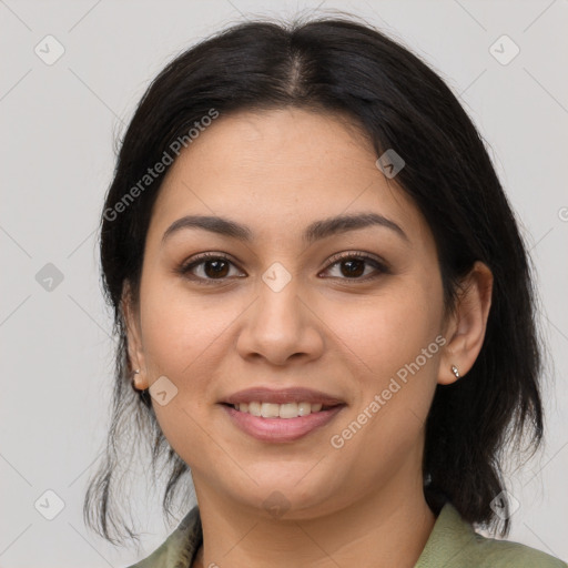 Joyful latino young-adult female with medium  brown hair and brown eyes