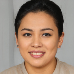 Joyful latino young-adult female with medium  brown hair and brown eyes