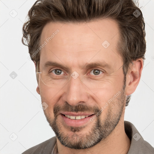 Joyful white adult male with short  brown hair and grey eyes