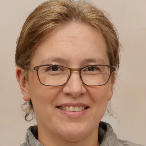 Joyful white adult female with medium  brown hair and brown eyes