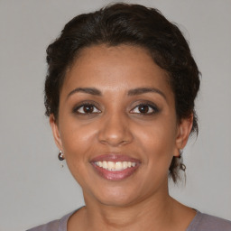 Joyful white adult female with medium  brown hair and brown eyes