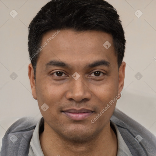 Joyful latino young-adult male with short  black hair and brown eyes