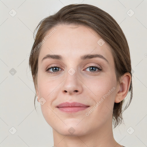 Joyful white young-adult female with medium  brown hair and grey eyes