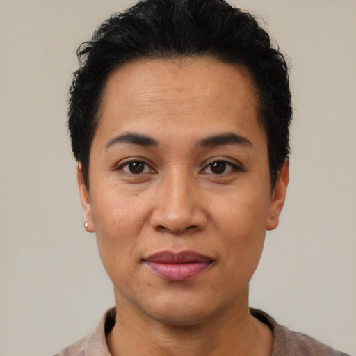 Joyful latino young-adult female with short  black hair and brown eyes
