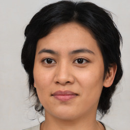 Joyful asian young-adult female with medium  black hair and brown eyes