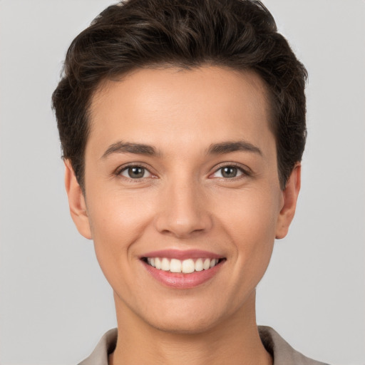 Joyful white young-adult female with short  brown hair and brown eyes