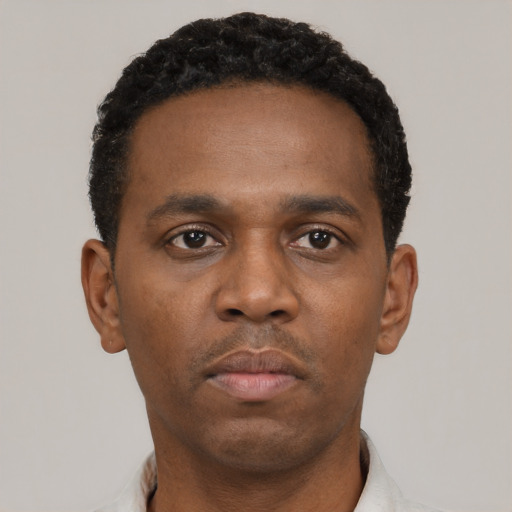 Neutral black young-adult male with short  black hair and brown eyes