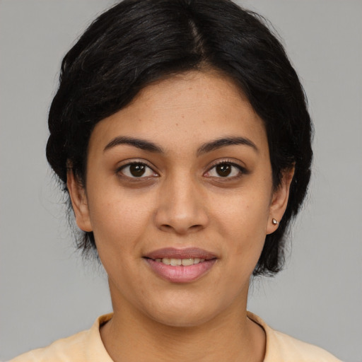 Joyful latino young-adult female with medium  black hair and brown eyes