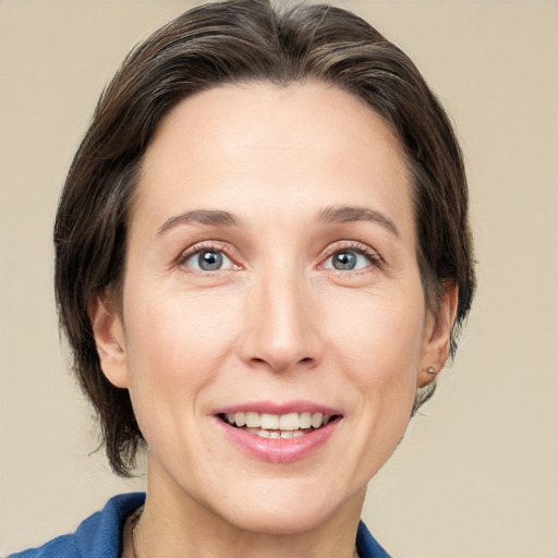 Joyful white adult female with medium  brown hair and grey eyes