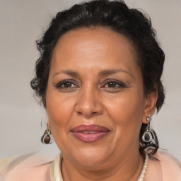 Joyful latino adult female with medium  brown hair and brown eyes