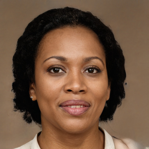 Joyful black adult female with medium  black hair and brown eyes