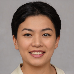 Joyful asian young-adult female with short  brown hair and brown eyes