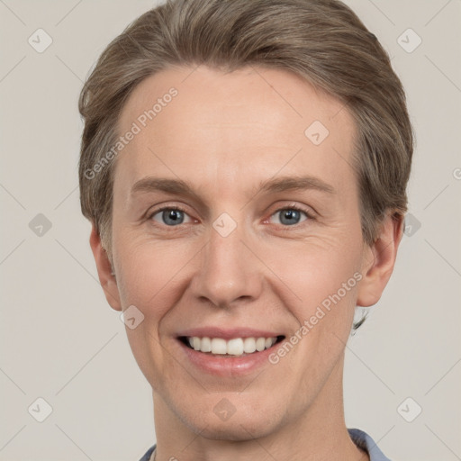 Joyful white adult female with short  brown hair and grey eyes