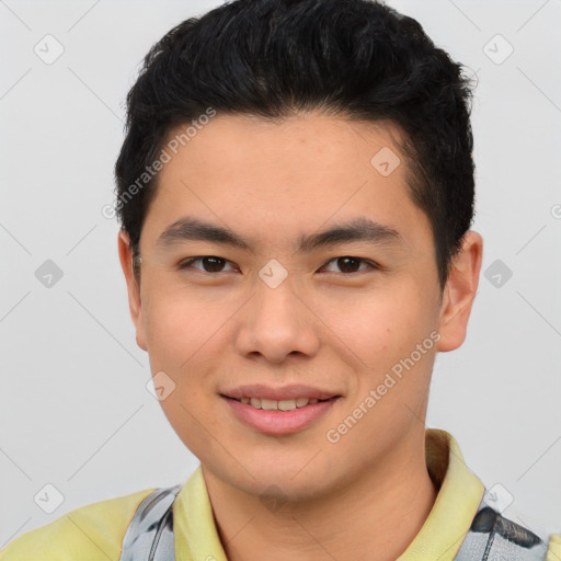 Joyful asian young-adult male with short  brown hair and brown eyes