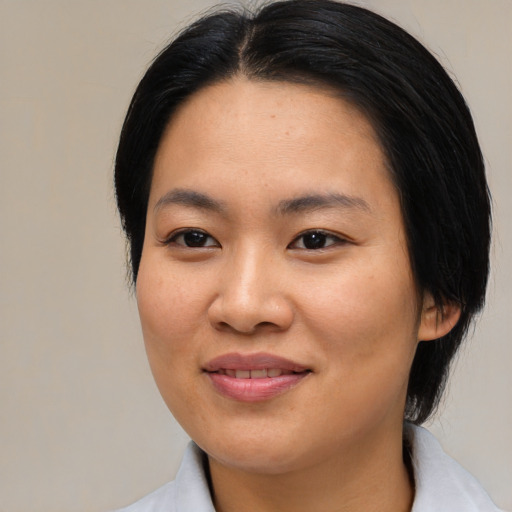 Joyful asian young-adult female with medium  brown hair and brown eyes