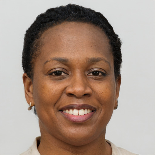Joyful black adult female with short  brown hair and brown eyes