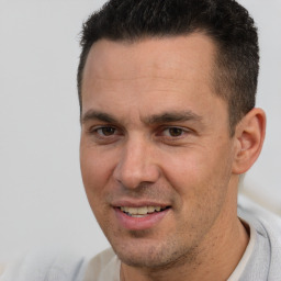 Joyful white adult male with short  brown hair and brown eyes