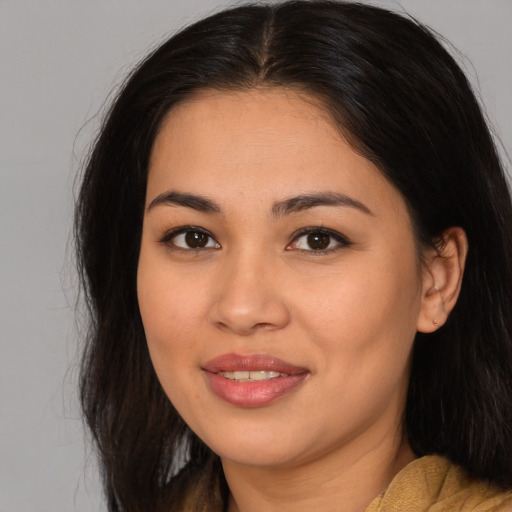 Joyful asian young-adult female with long  brown hair and brown eyes