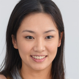 Joyful asian young-adult female with long  brown hair and brown eyes