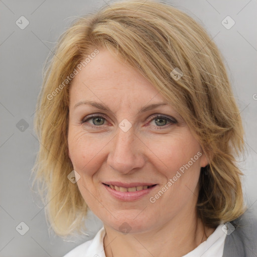 Joyful white adult female with medium  brown hair and blue eyes