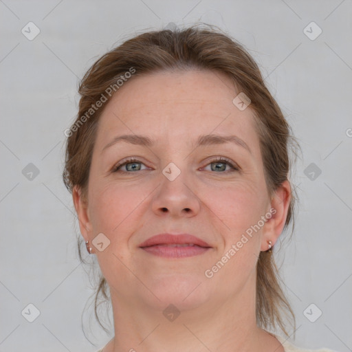 Joyful white adult female with medium  brown hair and grey eyes