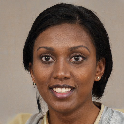 Joyful black young-adult female with medium  black hair and brown eyes