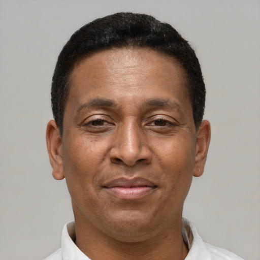 Joyful latino adult male with short  brown hair and brown eyes