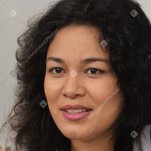 Joyful latino adult female with long  brown hair and brown eyes