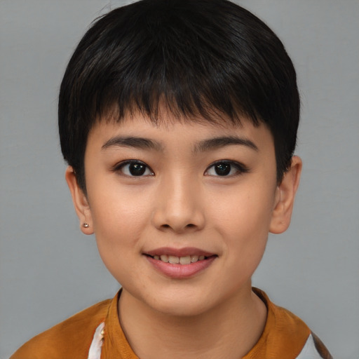 Joyful asian child female with short  brown hair and brown eyes