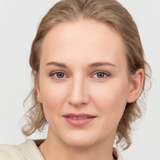 Joyful white young-adult female with medium  brown hair and blue eyes