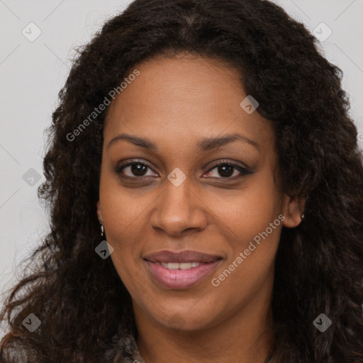 Joyful black young-adult female with long  brown hair and brown eyes