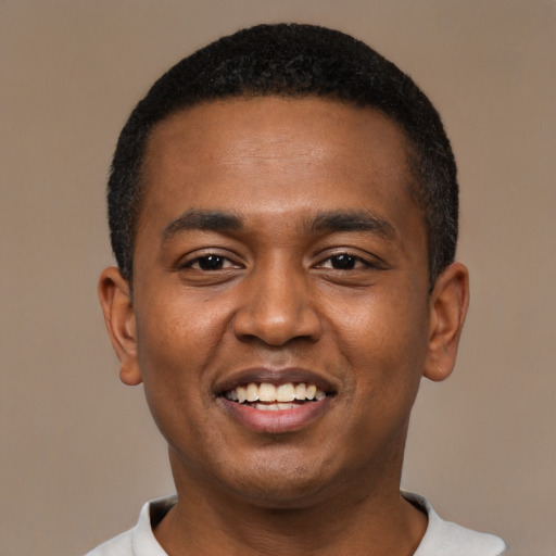 Joyful black young-adult male with short  black hair and brown eyes