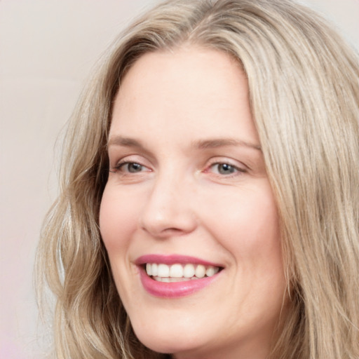 Joyful white young-adult female with long  brown hair and blue eyes