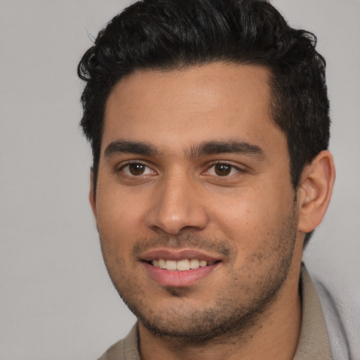 Joyful white young-adult male with short  black hair and brown eyes