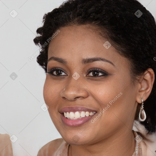 Joyful black young-adult female with long  brown hair and brown eyes