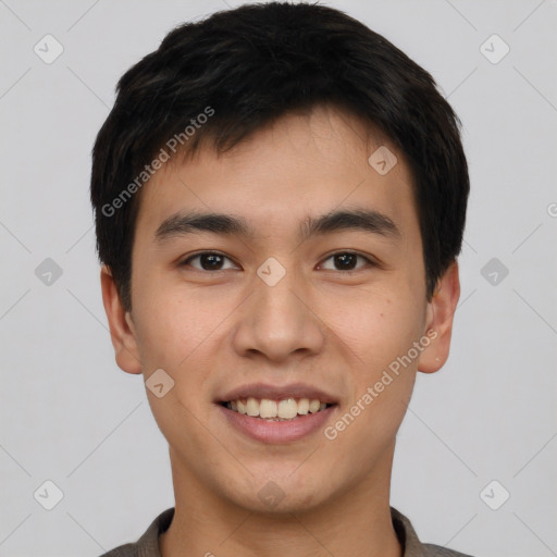 Joyful asian young-adult male with short  black hair and brown eyes