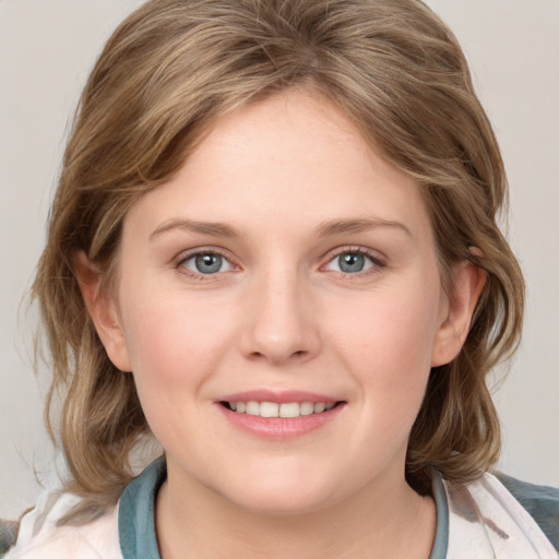 Joyful white young-adult female with medium  brown hair and blue eyes