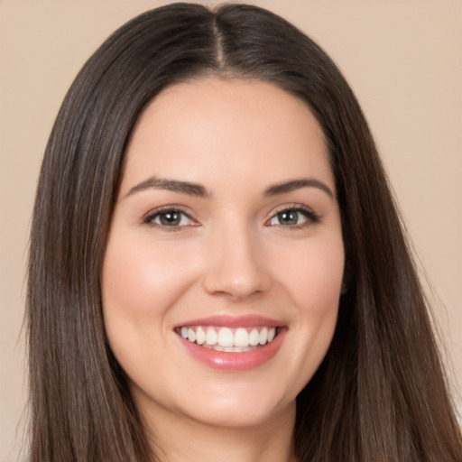 Joyful white young-adult female with long  brown hair and brown eyes