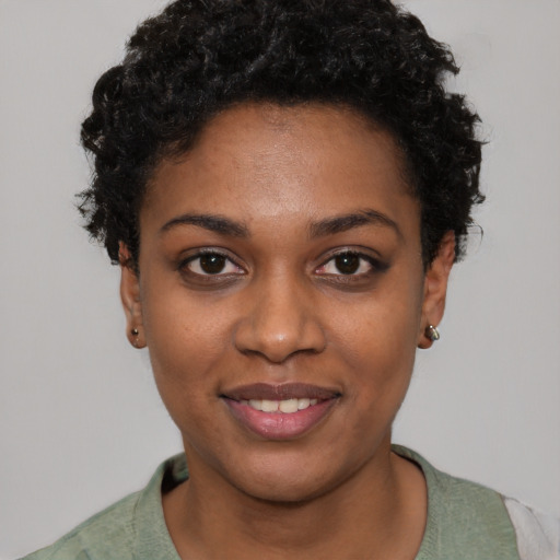 Joyful black young-adult female with short  brown hair and brown eyes