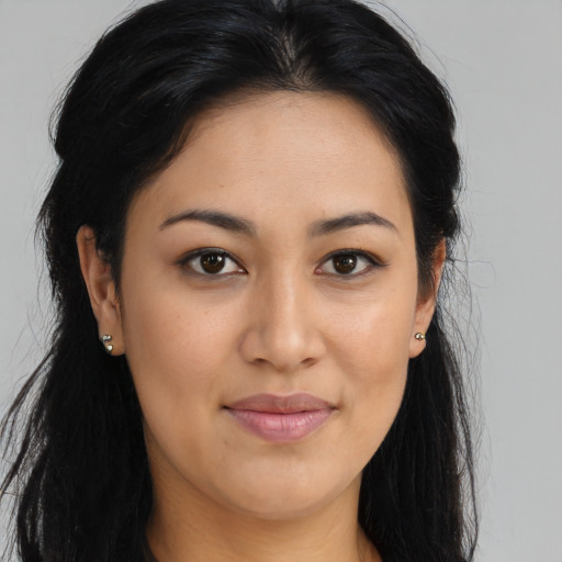 Joyful latino young-adult female with long  brown hair and brown eyes