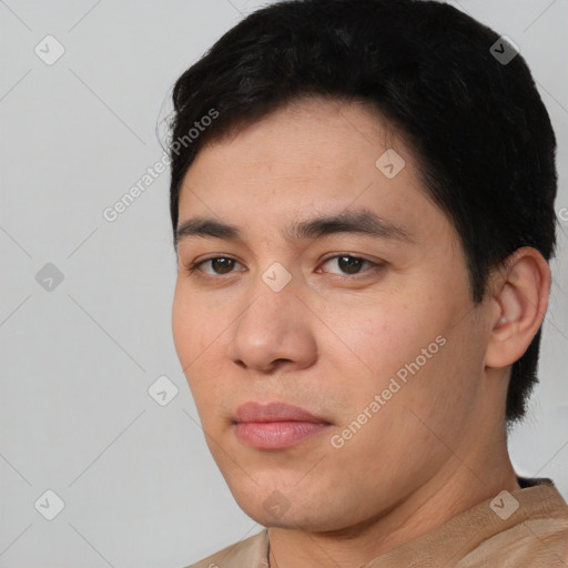 Joyful asian young-adult male with short  black hair and brown eyes