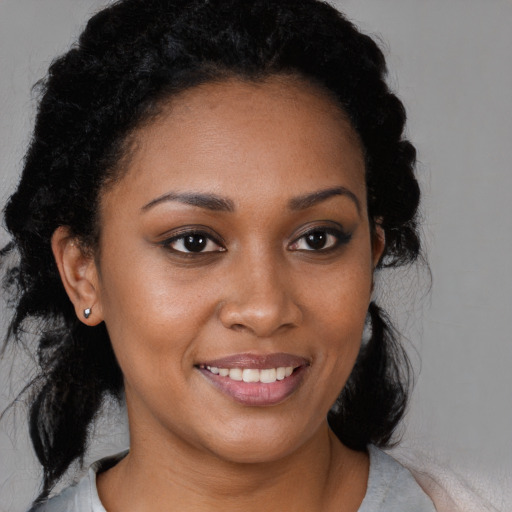 Joyful black young-adult female with medium  brown hair and brown eyes