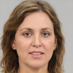 Joyful white young-adult female with long  brown hair and green eyes