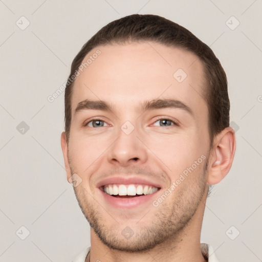 Joyful white young-adult male with short  brown hair and brown eyes