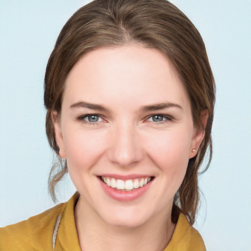 Joyful white young-adult female with medium  brown hair and grey eyes